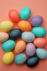 Fototapeta na wymiar Many colored, colored eggs lie on a pink background, Easter.
