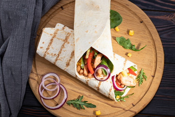 Mexican burrito with chicken, pepper and beans. Top view