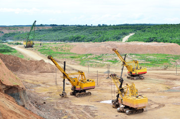 Huge mining excavators in the limestone open-pit. Biggest digger working in dolomite quarry....