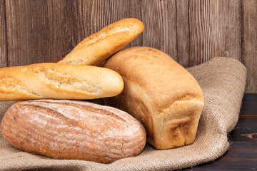 baked bread and baguette on wooden table background