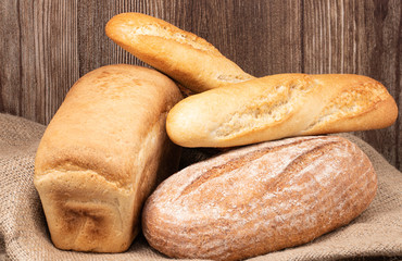 baked bread and baguette on wooden table background