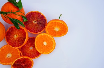 Platter of orange and mandarosa red clementines cut in half on a white platter