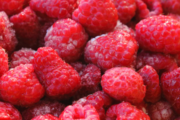 Fresh ripe frozen raspberries. Close-up. Background. Texture.