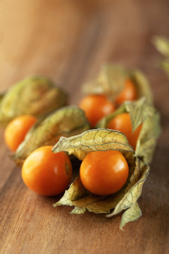 Ripe yellow physalis peruviana on wooden background