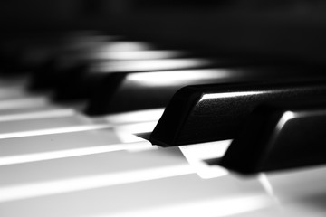 Piano keyboard close up in monochrome with blurred background