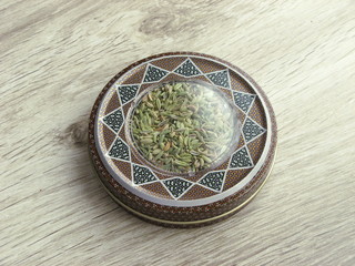  Dry Organic Fennel Seeds into handcraft box on wooden background. Benefits Of Fennel Seeds For Skin, Hair, And Health.
