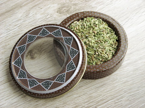 Fennel seeds spice vecto into handcraft box on wooden background. Fennel seeds benefits lactating women.