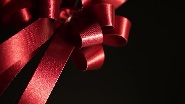 red ribbons on black for anniversary , party and shopping background