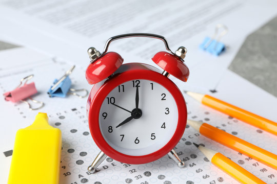 Test score sheet, alarm clock and stationery, close up