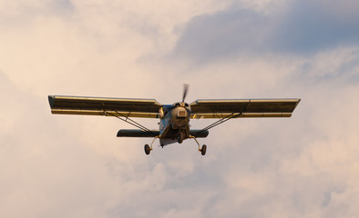 Homemade plane in a cloudy sky.