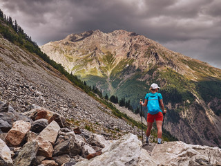 Fototapeta premium Young tourist girl looking into the valley in Caucasus mountains