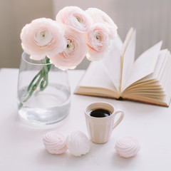 Obraz na płótnie Canvas Spring home decor. Book, flowers and coffee cup in morning light. Good morning concept. Interior design of room 