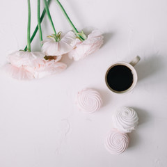Pink rose flowers, coffee and marshmallows on a white background. Flowers composition. Wallpaper, Flat lay, top view, copy space. 