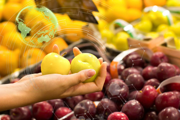 Woman hand choosing prunes at supermarket. Concept of healthy food, bio, vegetarian, diet.
