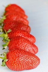 Ripe fresh organic strawberries on a blue background, place for text. Juicy Summer Berries.