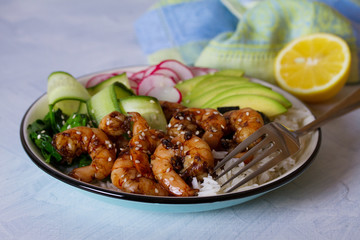 Shrimps prawns with rice, avocado, spinach, radish cucumber and  seaweed. Healthy food concept. horizontal image
