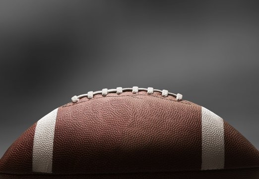 Classic american football ball on dark background