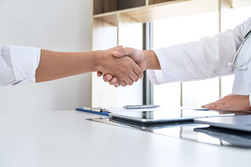 Finishing of consulting, Doctor and patient shaking hands after a good and successful treatment in the hospital, healthcare and assistance concept