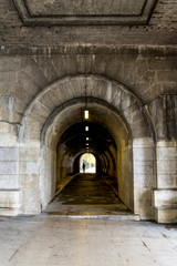 Pedestrian tunnel in Pont du Carrousel bridge at Seine river promenade in Paris city centre, France