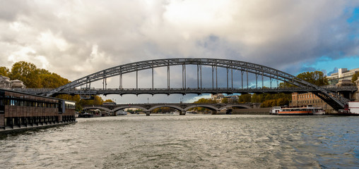 Naklejka premium A view to Viaduc d’Austerlitz steel bridge over Seine river while cruising, Paris, France