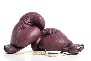 A pair of leather vintage boxing gloves on white background