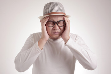 Naklejka premium Asian Man Close His Eyes, Stress or Headache Concept