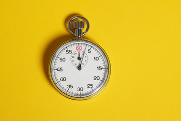 Classic stopwatch on a yellow background