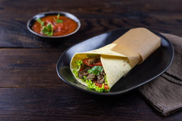 Burrito with beef with salsa souse