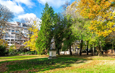 Beautiful autumn trees and a sculpture in Luxembourg Palace gardens, Paris, France
