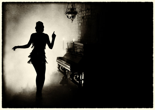 old fashioned photography. Dark mysterious silhouette retro woman style Great Gatsby. Girl dancing in short dress fashion old 1920s, backdrop room piano candle full smoke. Free space for invite text