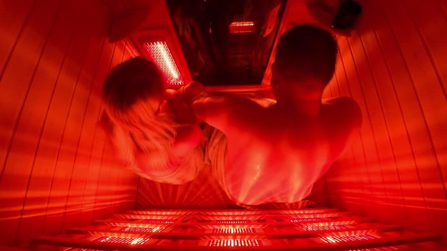 Happy couple relaxing in a luxury infrared sauna - Motion blurr
