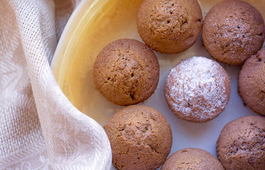 cupcakes cupcakes lie on a light plate with a linen beige cloth
