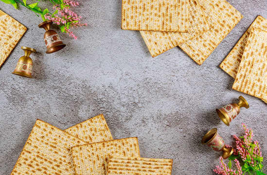 Four wine cups with matzah. Jewish holidays Passover concept.
