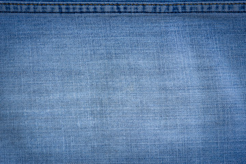Texture and detail of blue jeans with seam