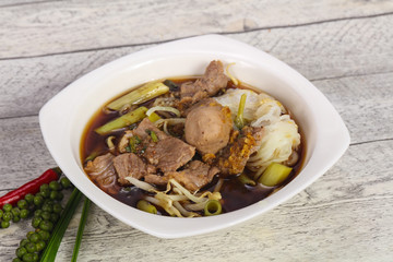 Thai style soup with meat and mushrooms