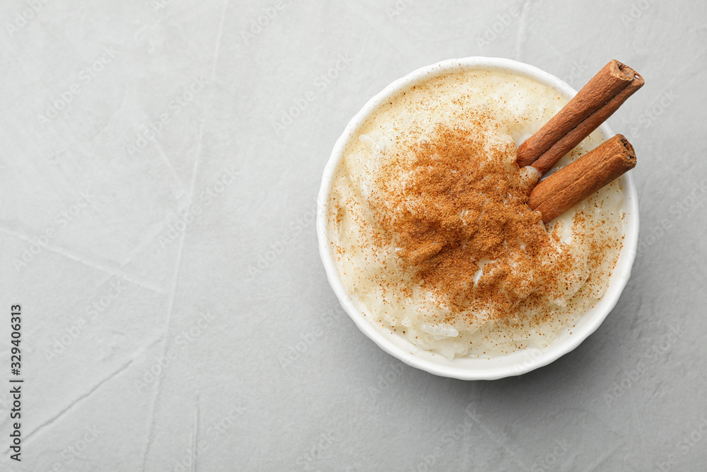 Canvas Prints delicious rice pudding with cinnamon on light table, top view. space for text