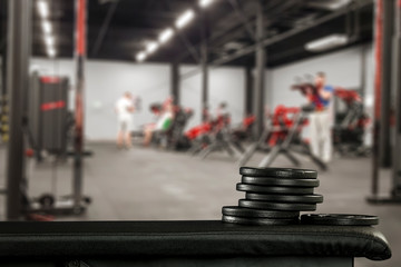 Fototapeta na wymiar Gym interior and black bench. Dumbbells composition and free space for your decoration. 