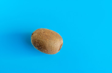 Kiwi fruit on a blue background. Exotic healthy fruit. Copy space for text.