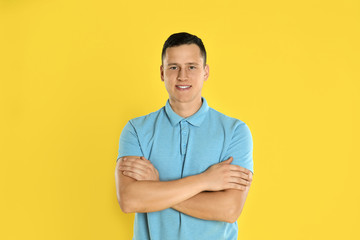 Happy handsome young man on yellow background