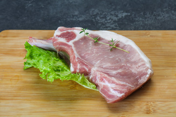 Raw pork bone steak over wooden