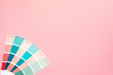 Selection of palette for painting, sample color catalog on a pink background, different shades of...