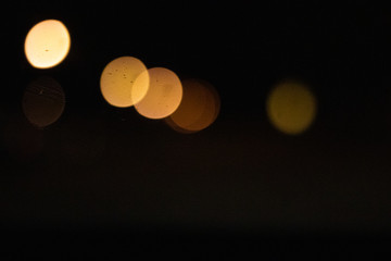 Lens flares caused by streetlights on a dark street