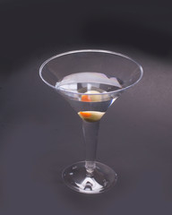 Dry martini served with an olive for a refreshing alcoholic drink for relaxation