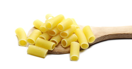 Uncooked smooth short tubes shape pasta also known as tubetti lisci in wooden spoon isolated on white background