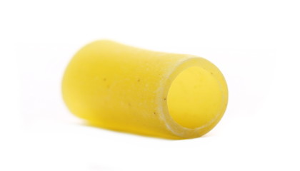 Uncooked short tube shape pasta also known as tubetti lisci isolated on white background