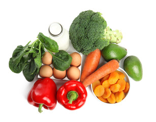 Fresh products rich in vitamin A on white background, top view