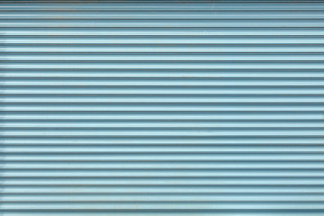 Abstract texture of light blue roller shutters.