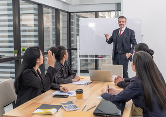 Business woman raise hand while meeting with Caucasian boss in office