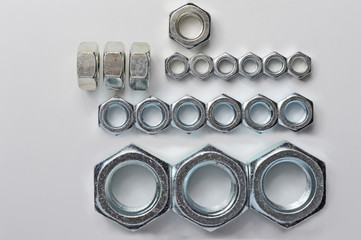 Big and small screw-nut. Concept. White background.