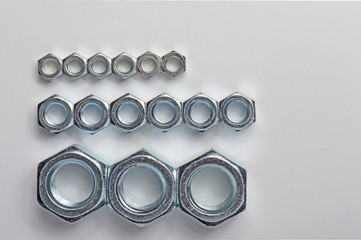 Big and small screw-nut. Concept. White background.